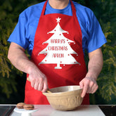 A personalised red Christmas apron. the apron has a Christmas tree design printed on it and the words "Harry's Christmas apron"